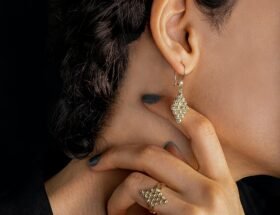 woman in gold diamond earrings