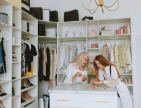 : Two women in a walk-in closet designing a closet space that fits your fashion needs