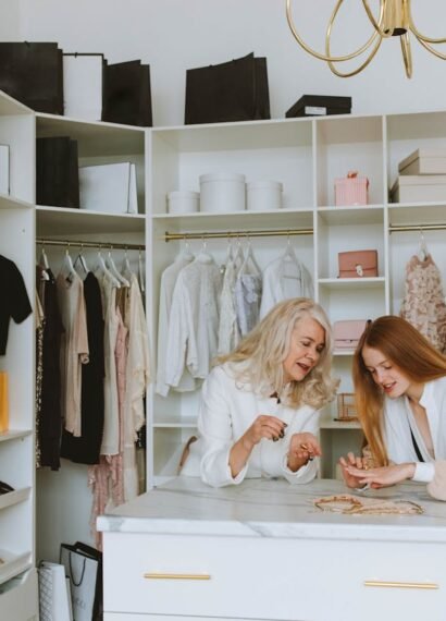 : Two women in a walk-in closet designing a closet space that fits your fashion needs