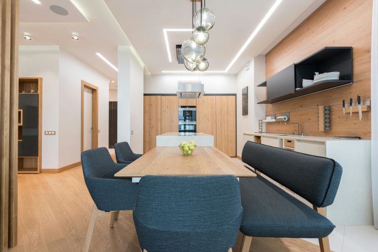 Contemporary kitchen and dining space featuring wood elements.
