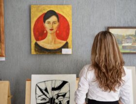: woman choosing art statement pieces for her home