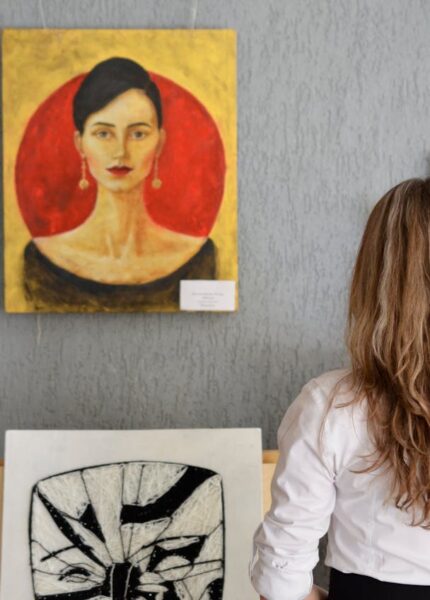 : woman choosing art statement pieces for her home